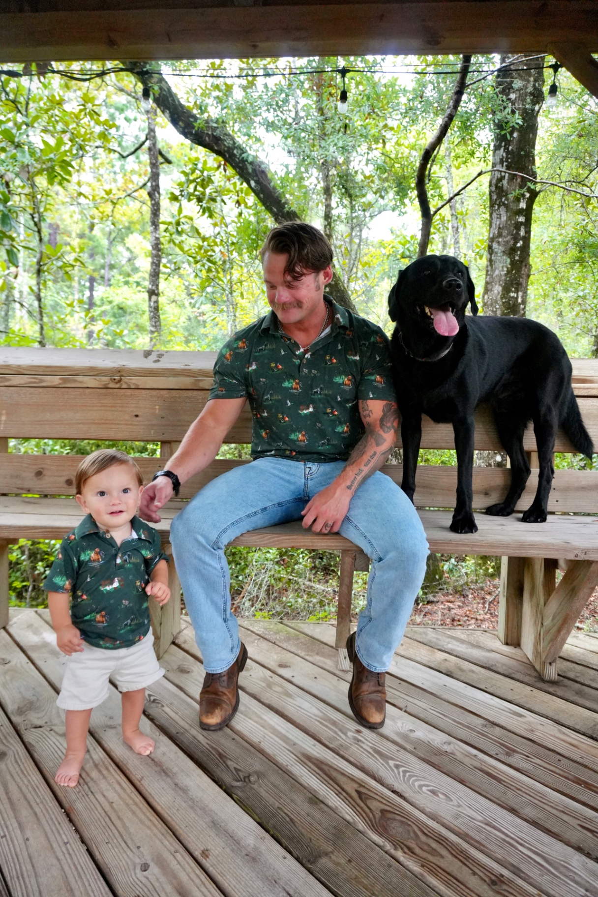 Father and son wearing matching Ekstrom Eagle polos with their dog