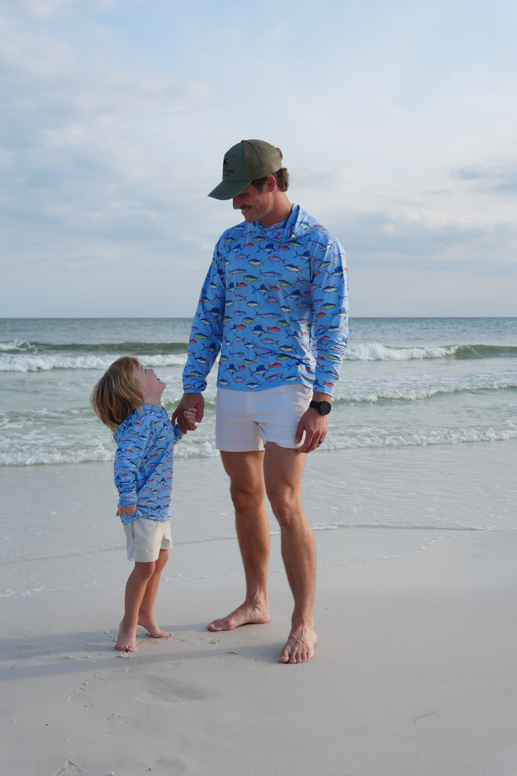 Father and son wearing matching Ekstrom Eagle hoodies on the beach